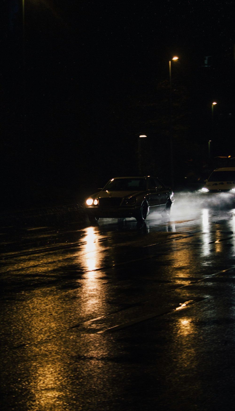 black sedan on road during night time