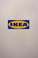 a white refrigerator with a blue and yellow ikea sticker on it