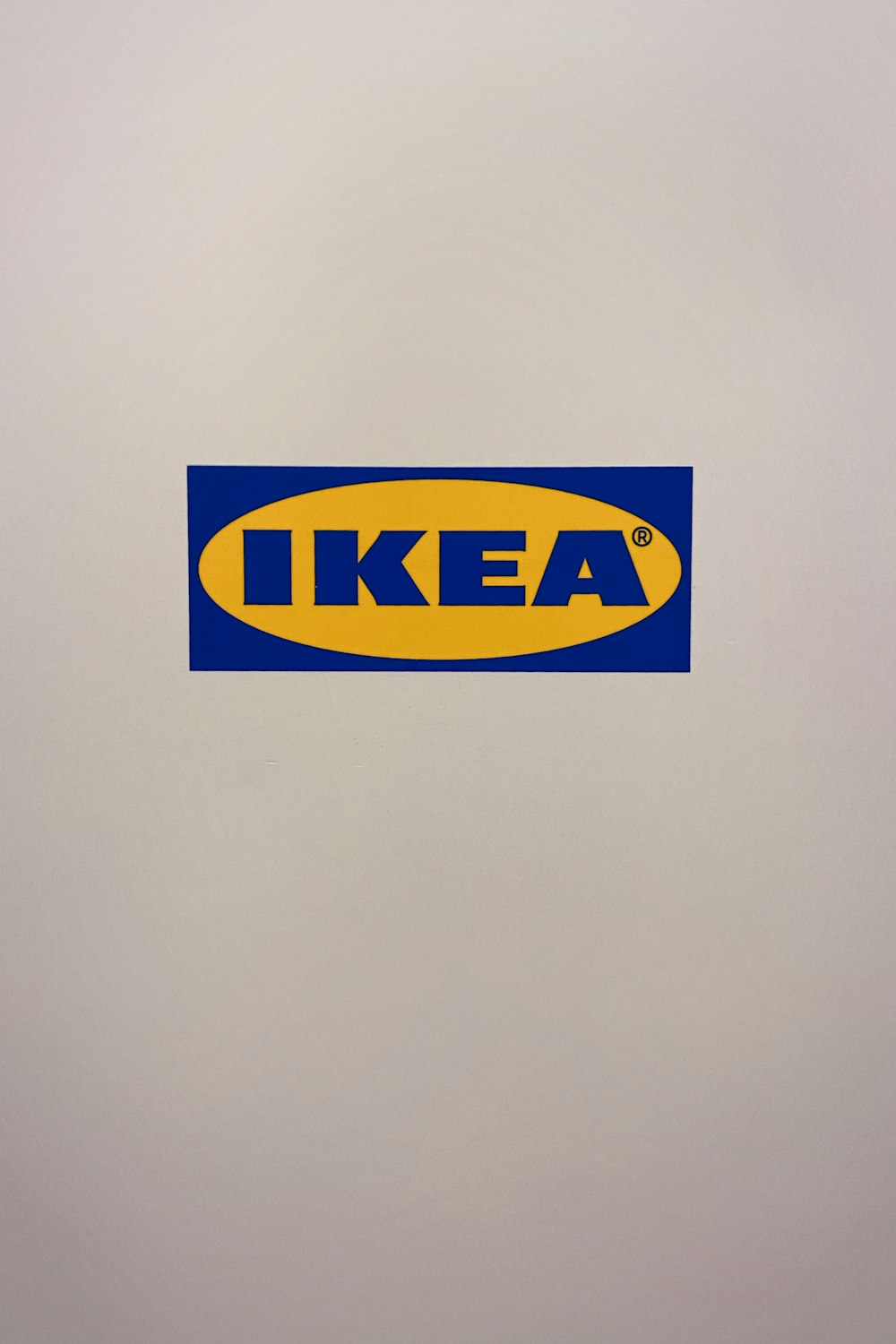 a white refrigerator with a blue and yellow ikea sticker on it