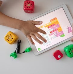 person holding white ipad on white table