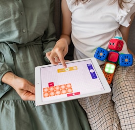 child playing game on white ipad