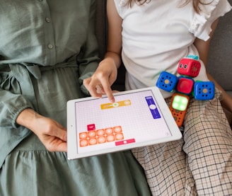 child playing game on white ipad