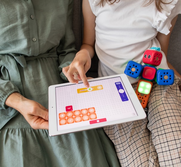 child playing game on white ipad