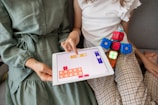child playing game on white ipad