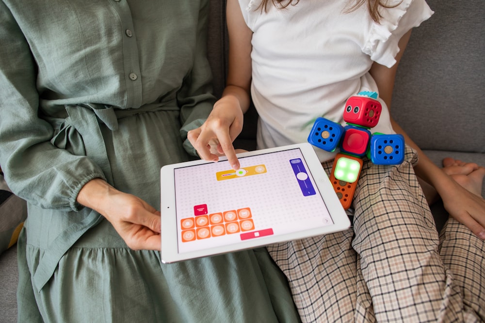 Bambino che gioca al gioco su iPad bianco