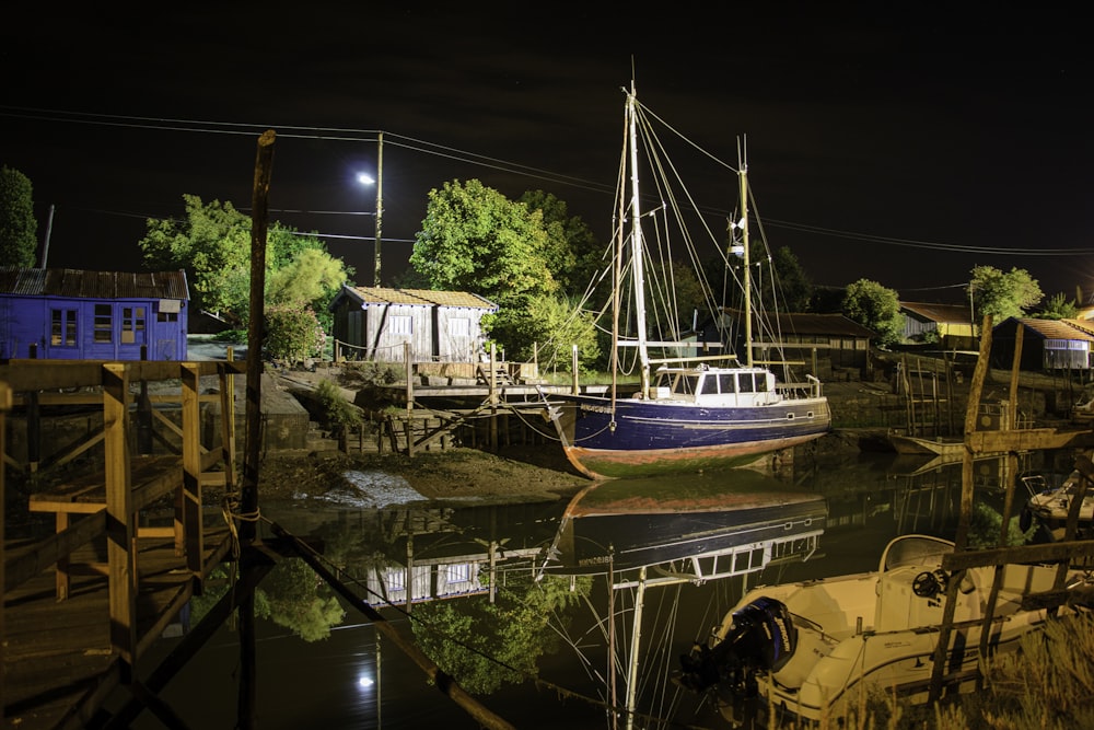 white and blue boat on water during night time