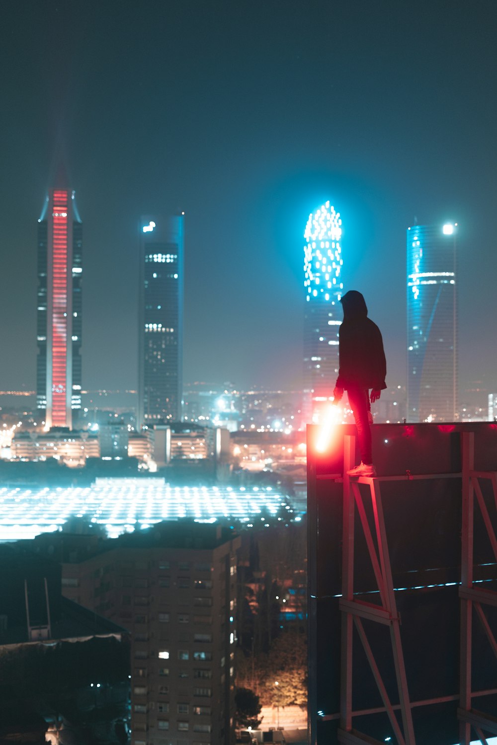 man in black jacket standing on top of building during night time