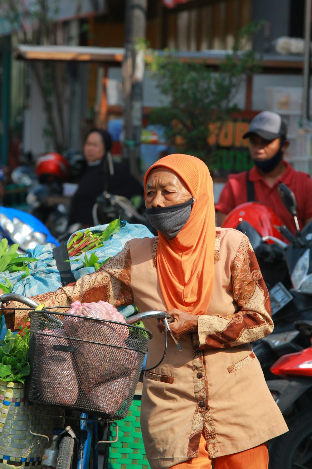 woman in yellow hijab and brown abaya dress holding brown basket