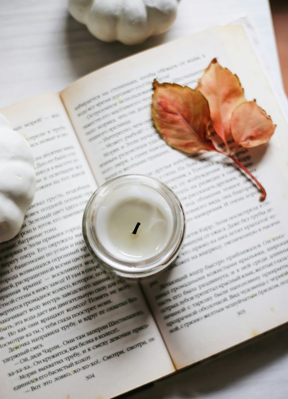 white ceramic cup on white book page