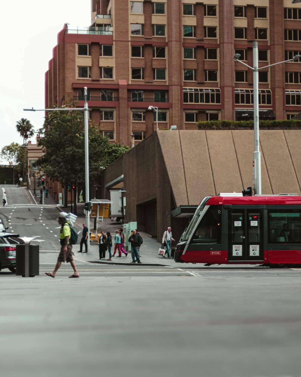 people walking on pedestrian lane near brown concrete building during daytime