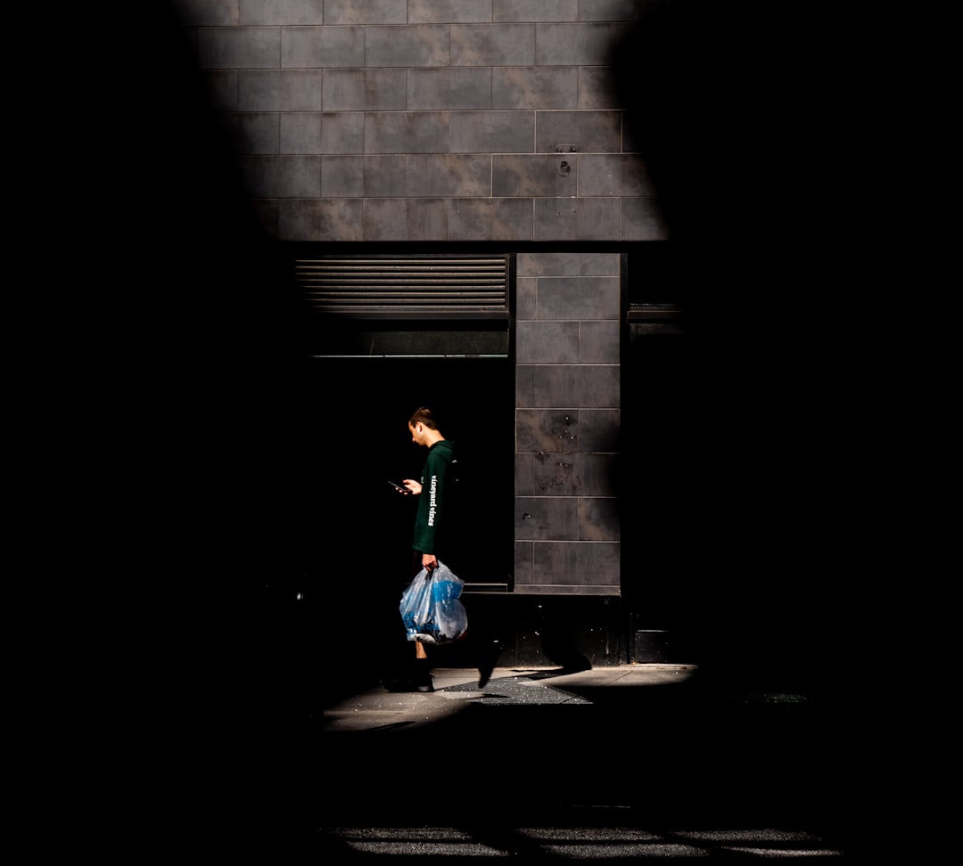 girl in green long sleeve shirt and blue pants walking on sidewalk