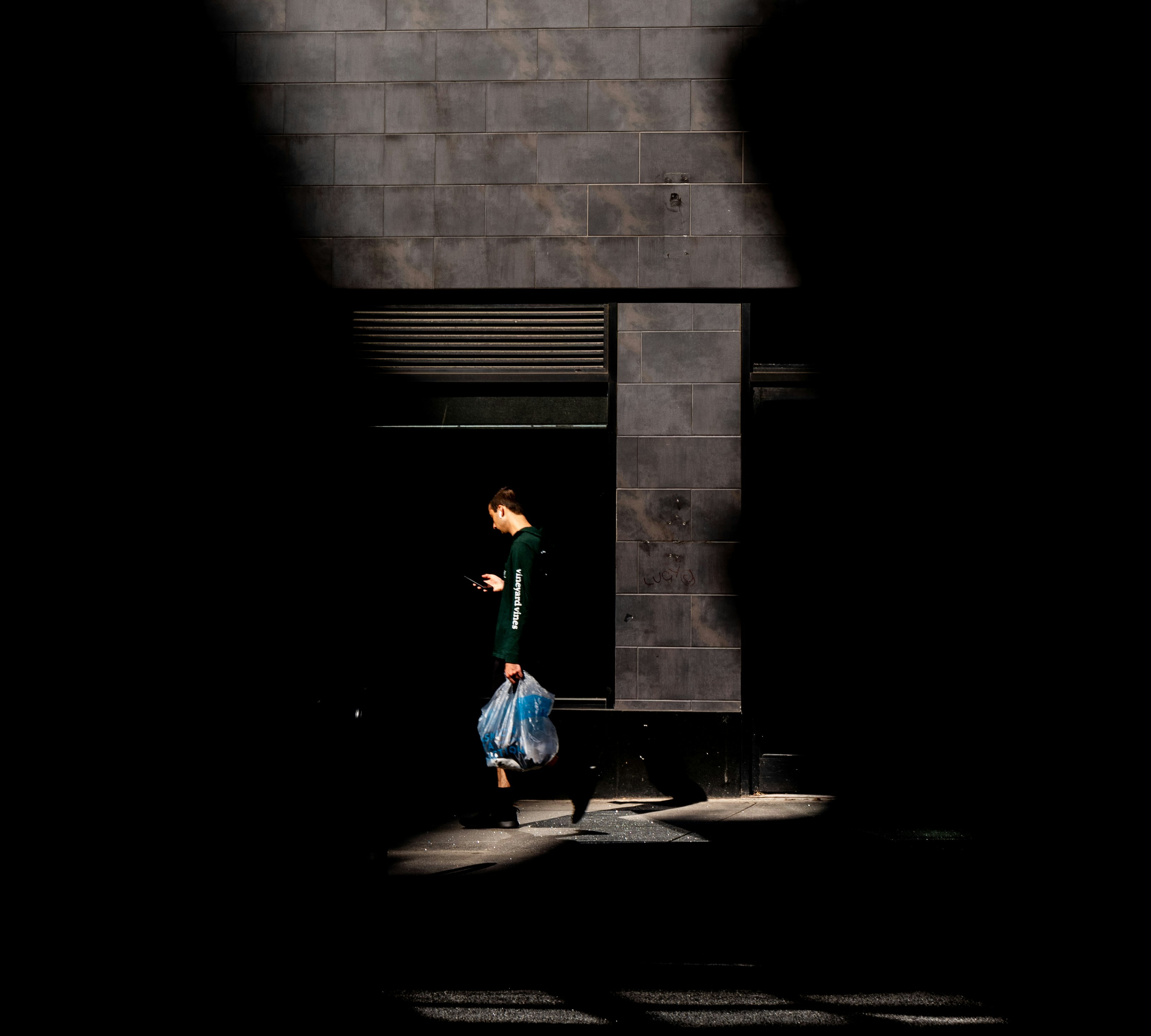 girl-in-green-long-sleeve-shirt-and-blue-pants-walking-on-sidewalk