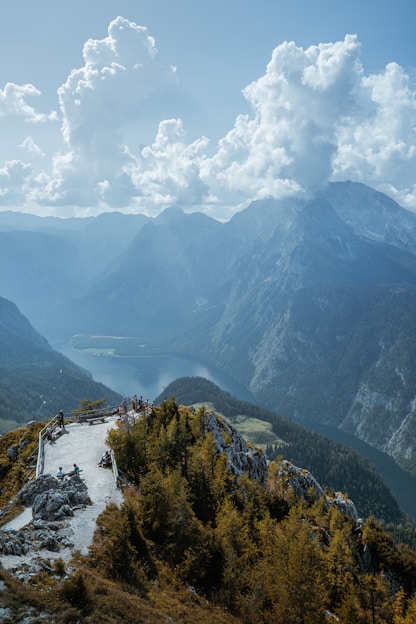 green trees on mountain under white clouds during daytime