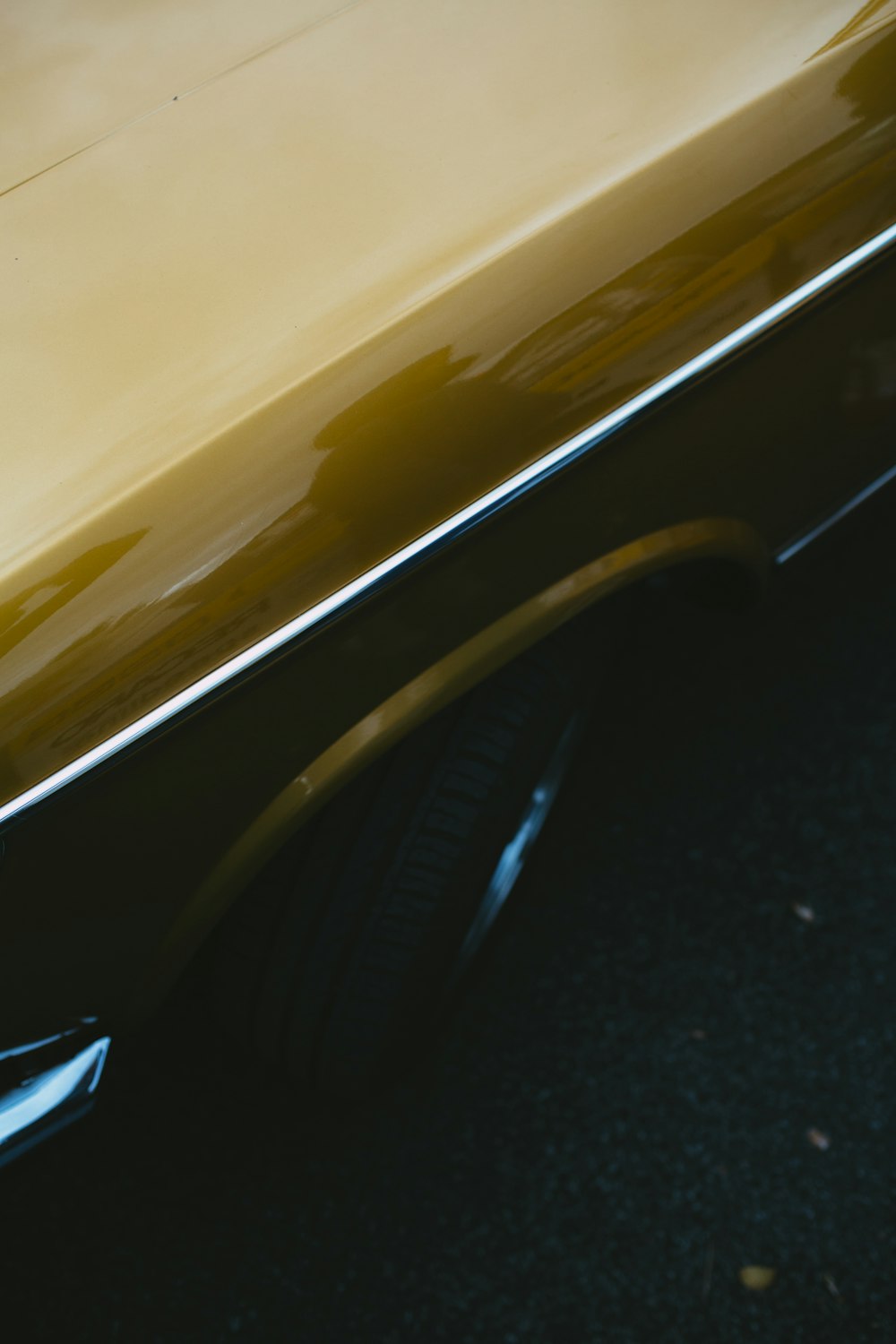 yellow car on black asphalt road