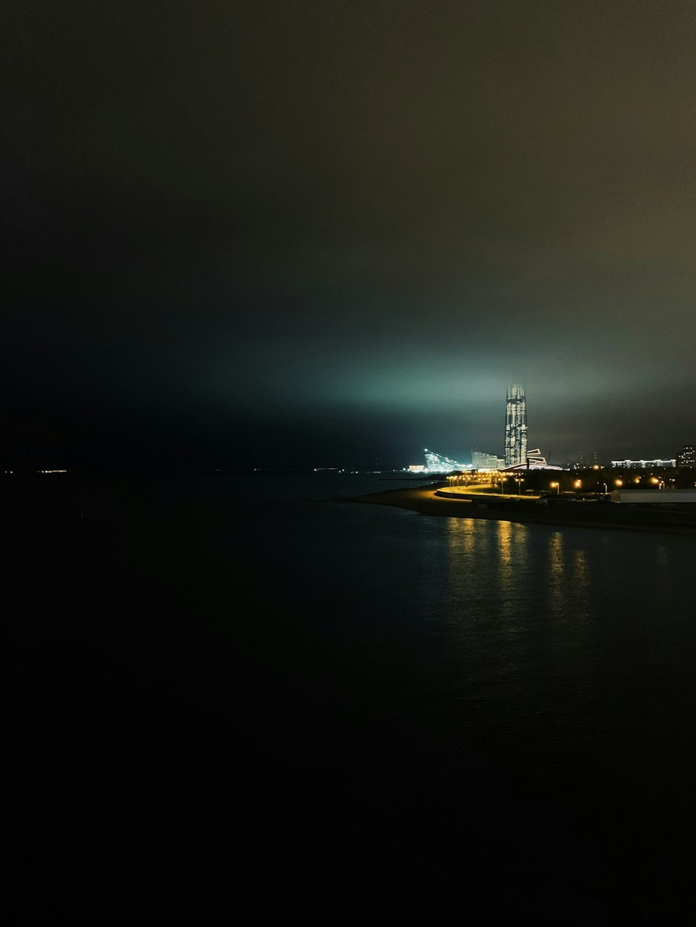 white and black ship on sea during night time