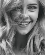 smiling woman in grayscale photography