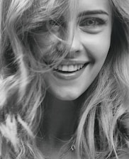 smiling woman in grayscale photography