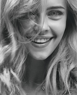 smiling woman in grayscale photography
