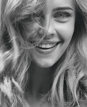 smiling woman in grayscale photography