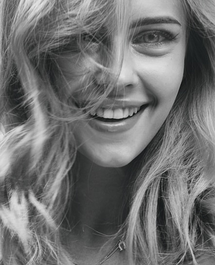 smiling woman in grayscale photography