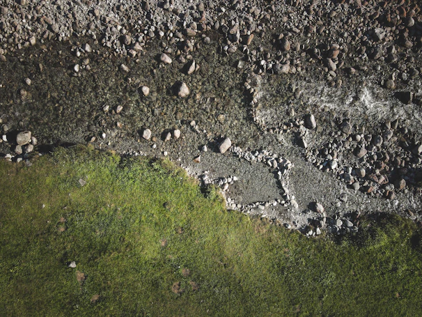 Before and after shots of a river cleaned using Ecosynth’s environmental solutions.