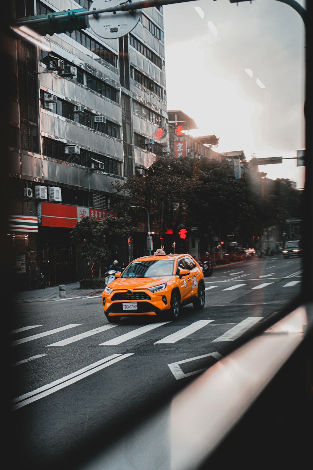 yellow cab on road during daytime