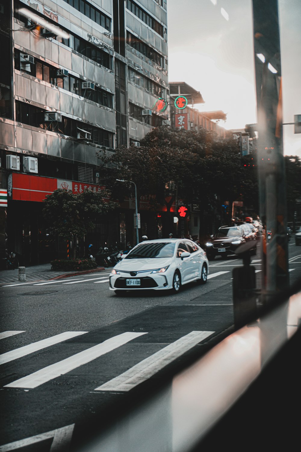 white sedan on road during daytime