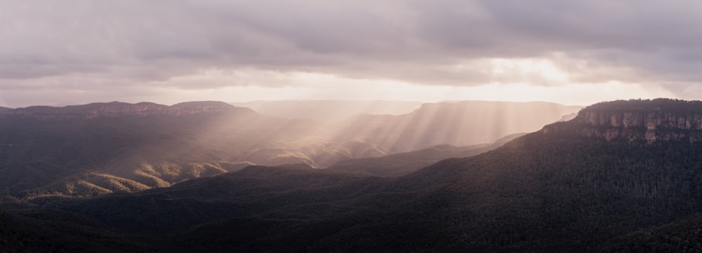 brown mountains under white clouds during daytime