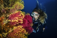 person in black goggles and black goggles under water