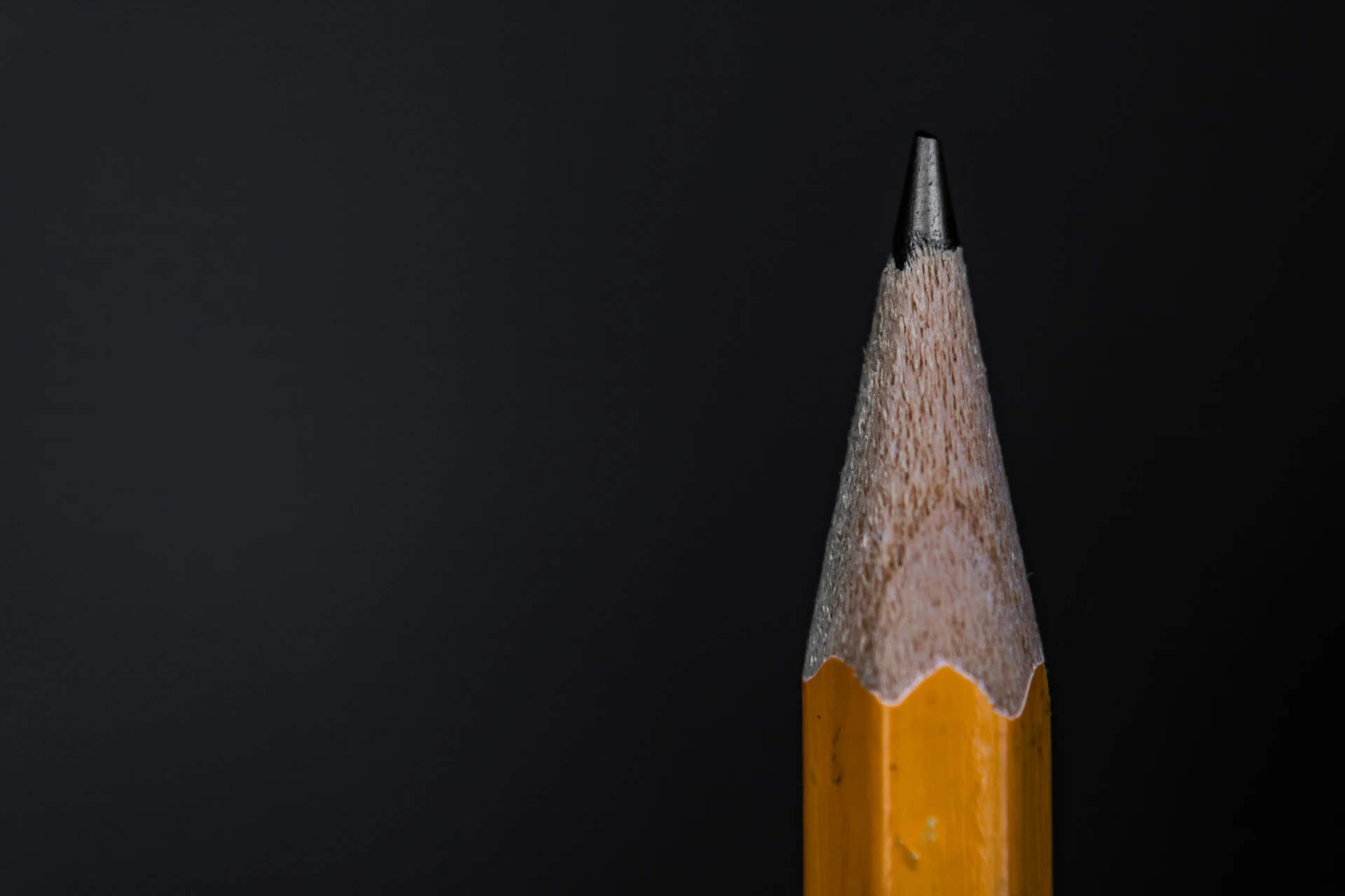 yellow and black pencil on black background