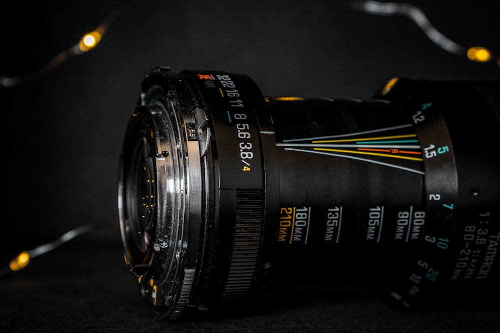 Lente de cámara Nikon negra sobre superficie negra