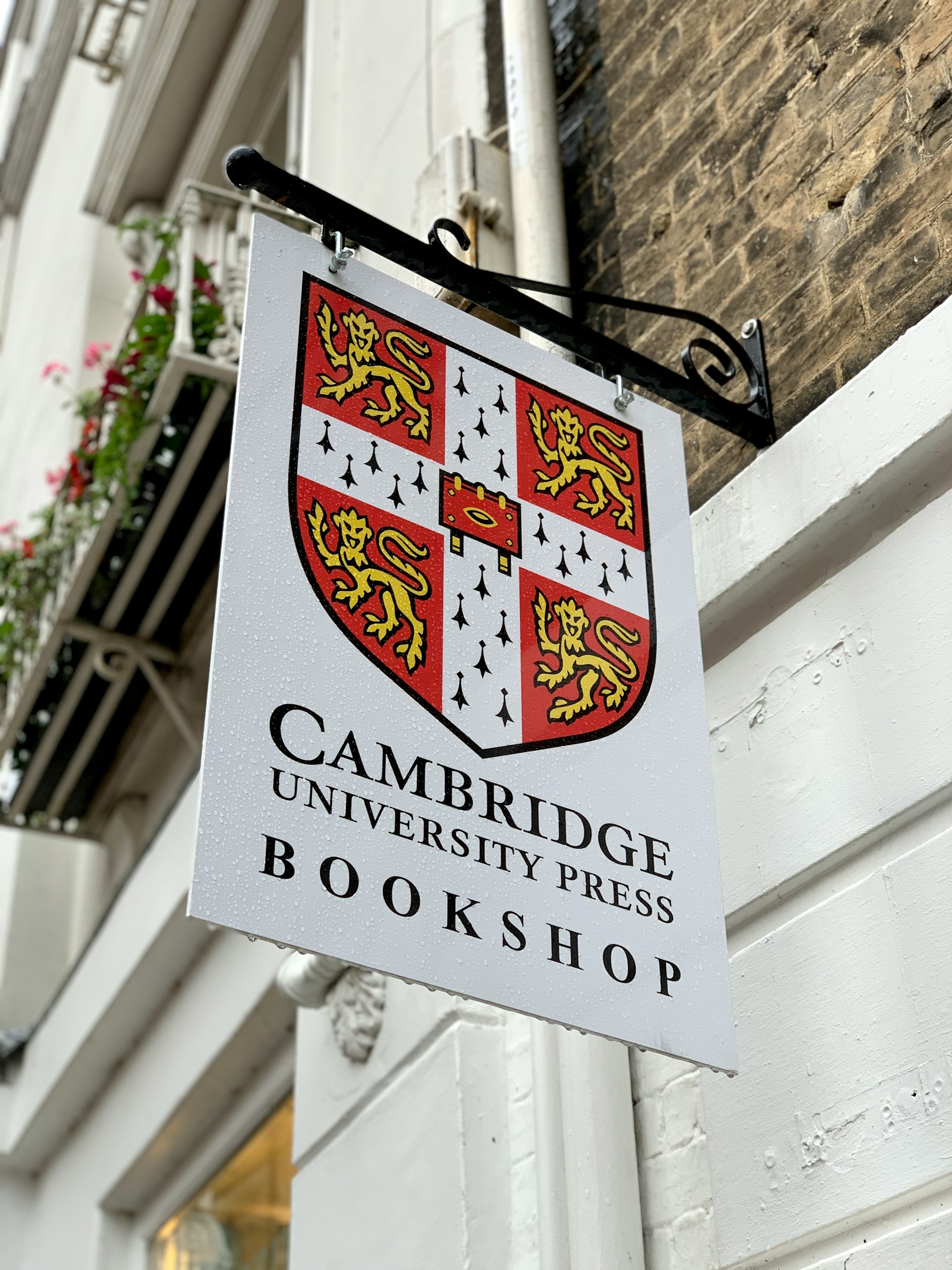 A sign hanging outside the Cambridge University Press Bookshop on Trinity Street in Cambridge, England.