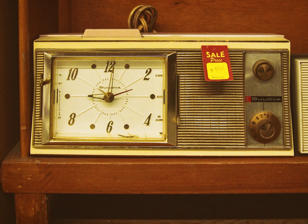 gold and white analog desk clock