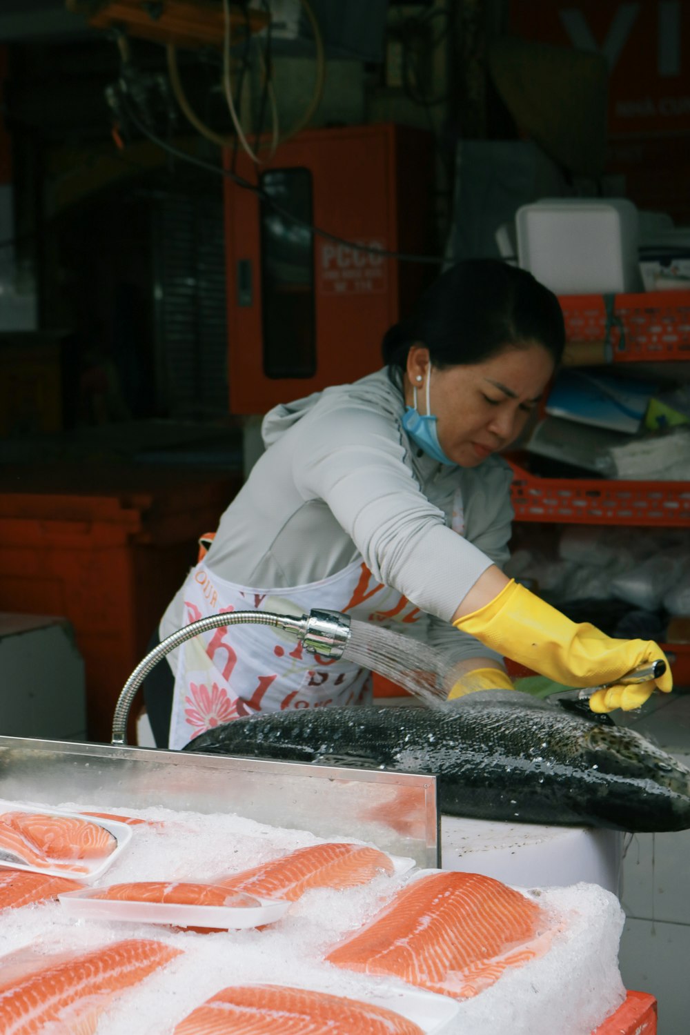 woman in white long sleeve shirt holding black fish