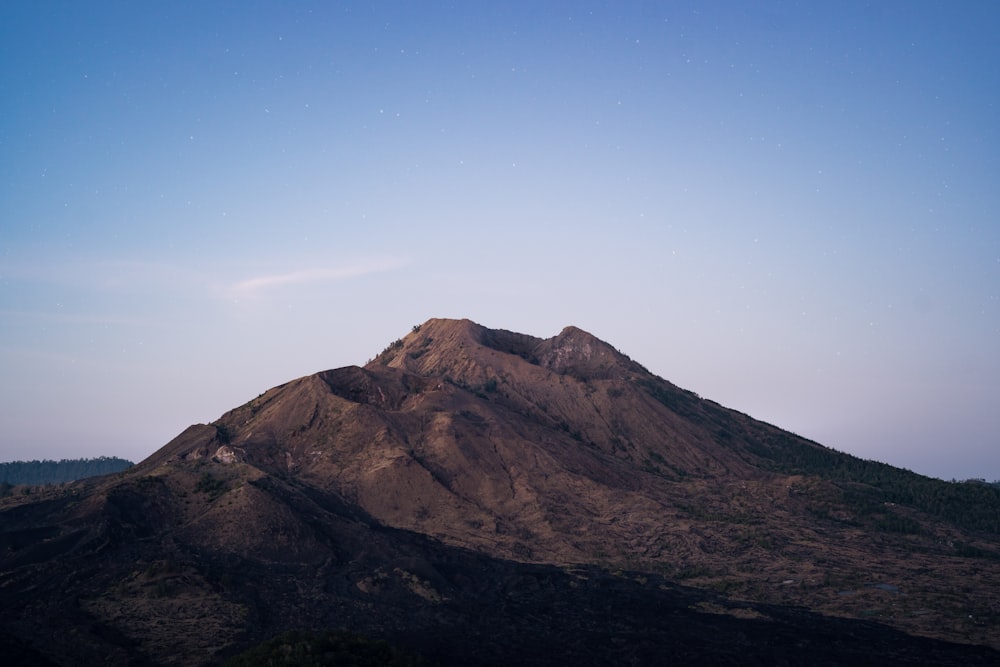 brown mountain under blue sky during daytime