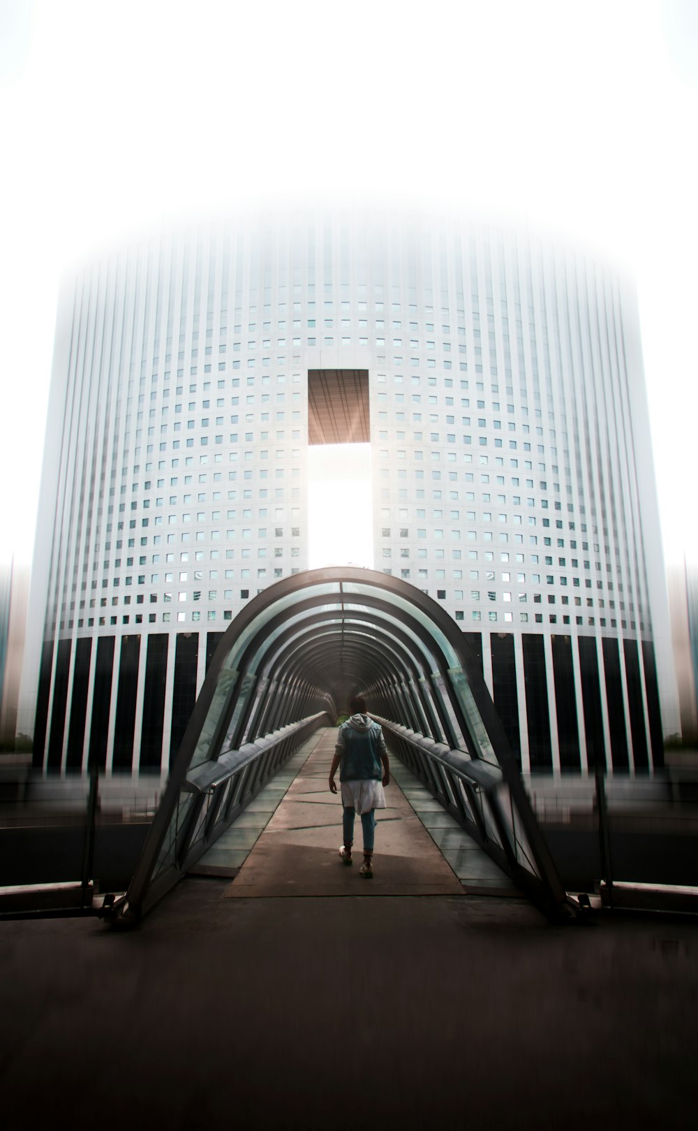 man in black jacket walking on gray concrete pathway