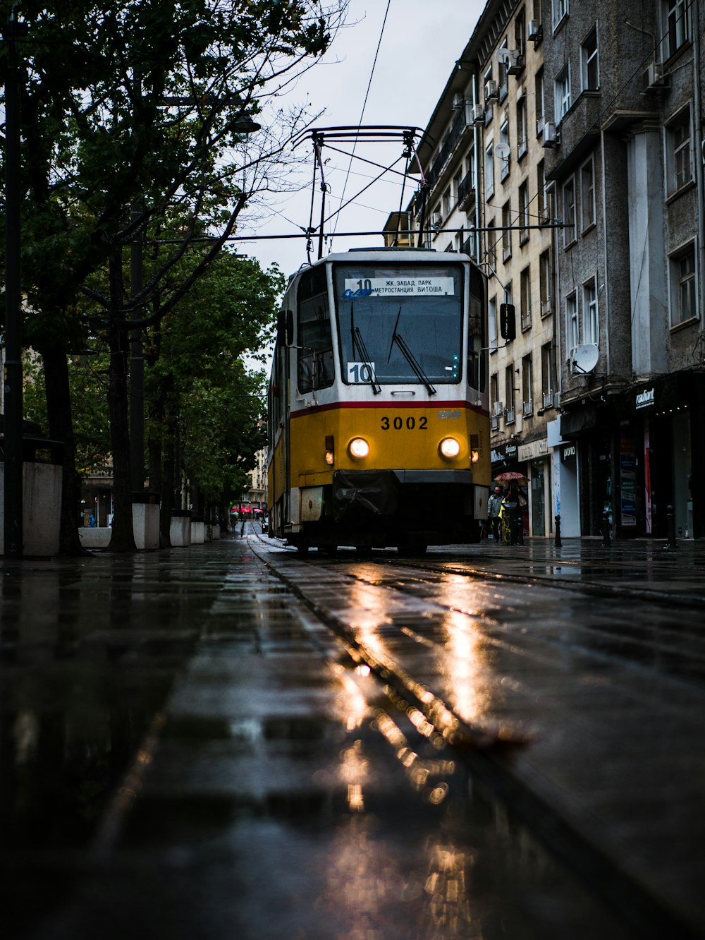 yellow tram on road during daytime