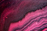 Close-up of a shimmering pink slime with glitter swirls.