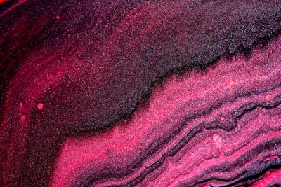 Close-up of a shimmering pink slime with glitter swirls.