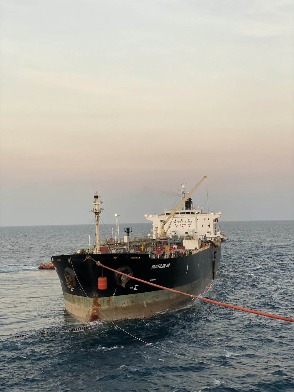 black and white ship on sea under white sky during daytime