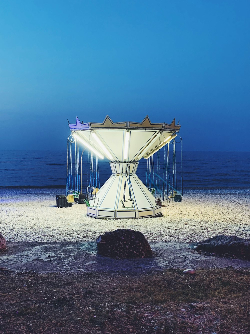 white and brown metal structure on beach during daytime