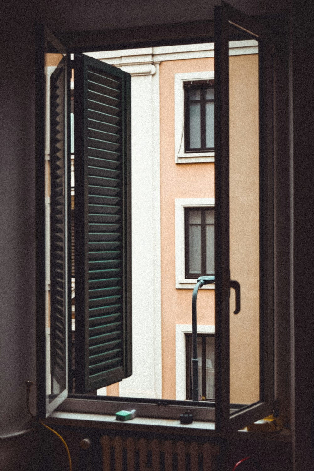 black wooden door near white concrete building