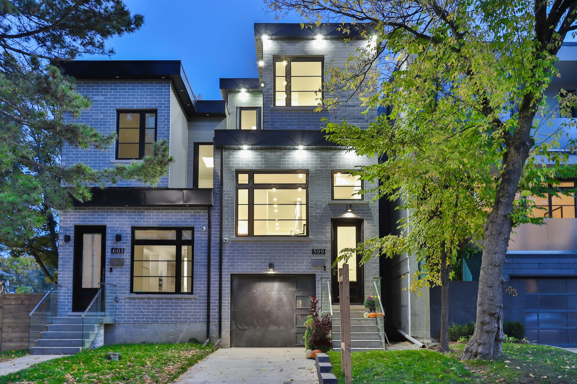 brown and white concrete house near green trees during daytime
