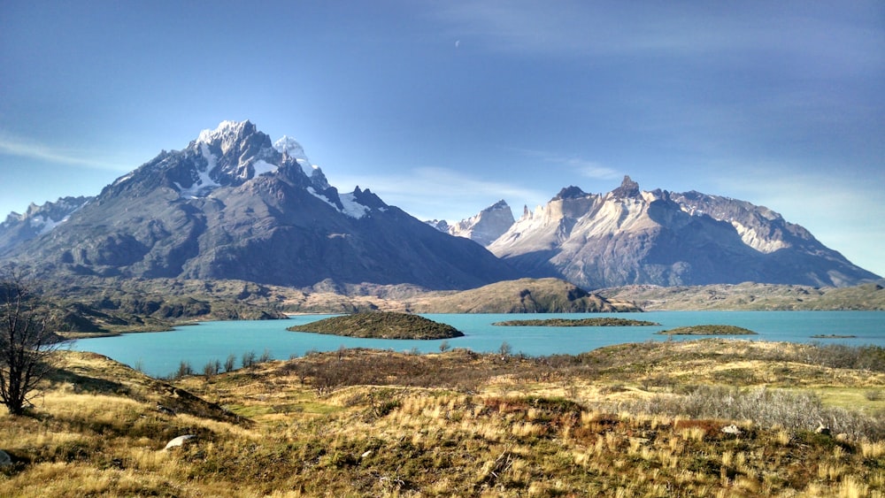 a mountain range with a lake in the foreground