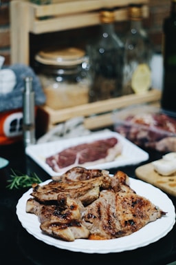 A warm, inviting kitchen scene with a rustic grill and fresh Mediterranean ingredients on a wooden table.