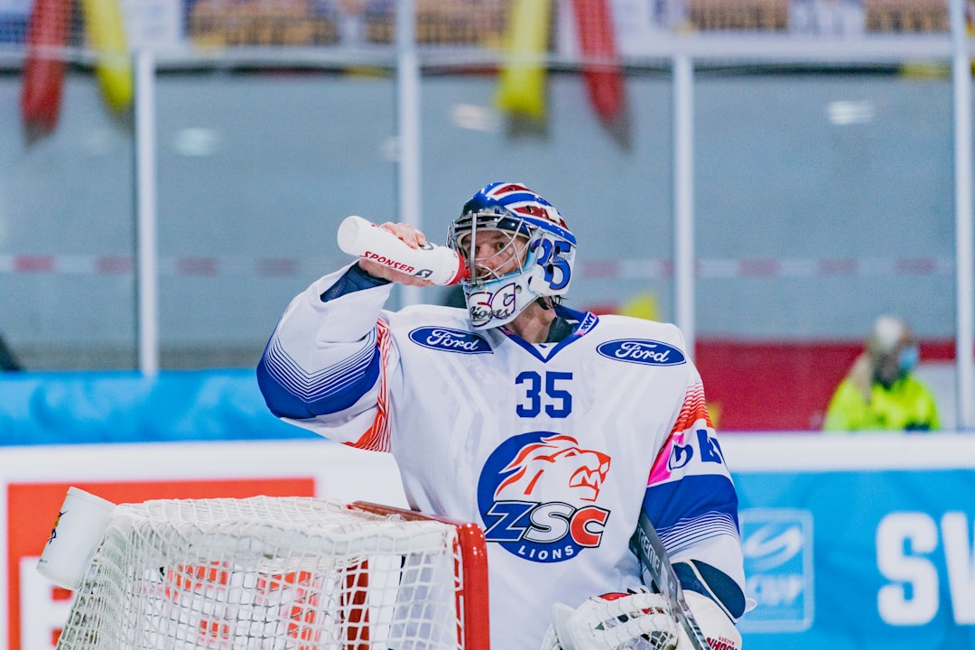 man in white and blue jersey shirt wearing blue helmet