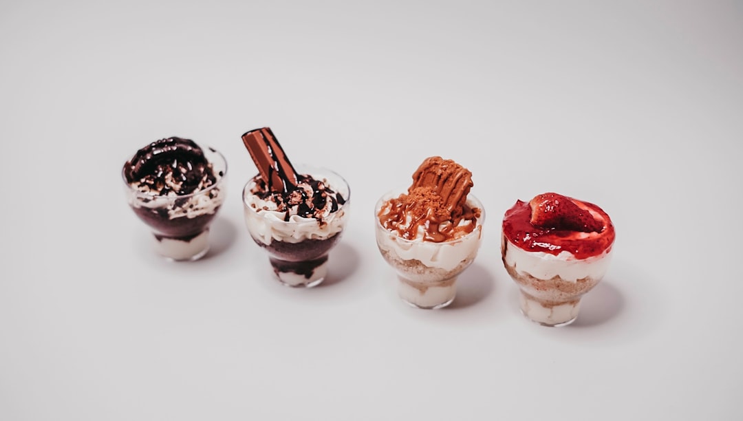 two white and brown ice cream in clear glass cups