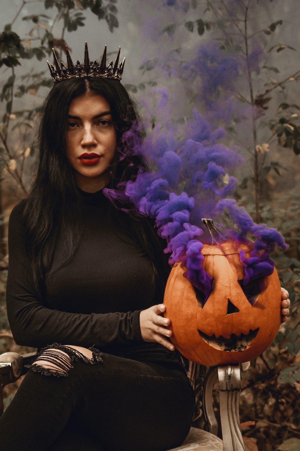 woman in black long sleeve shirt holding jack o lantern