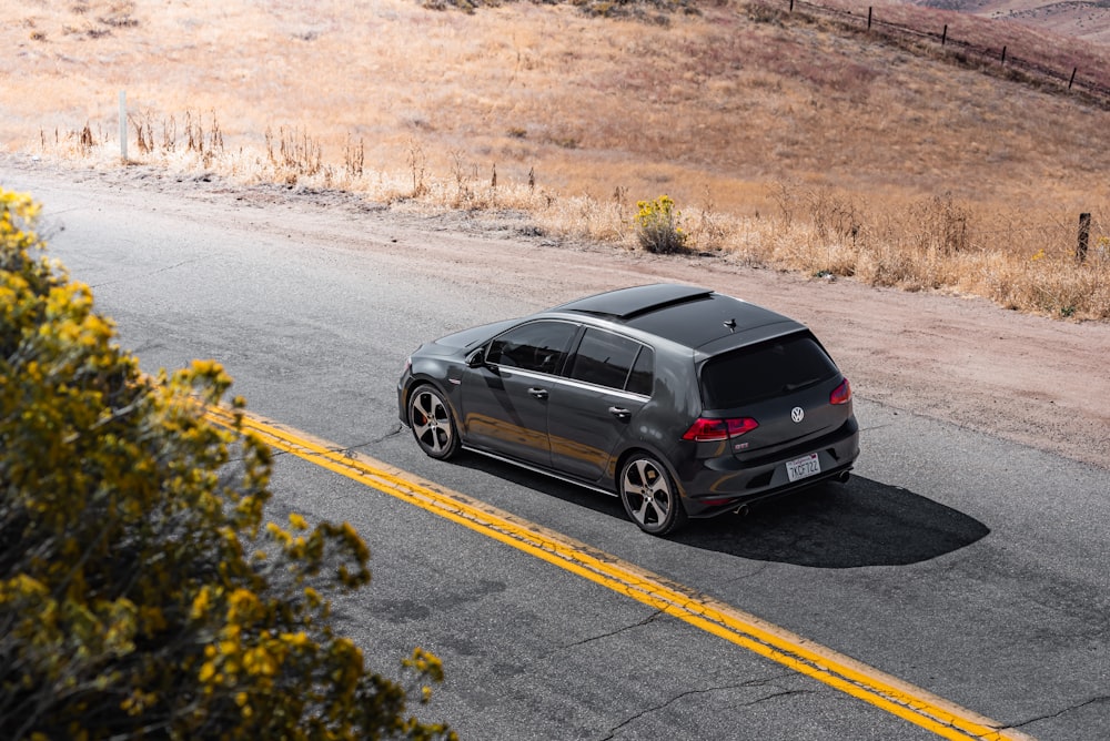 black suv on gray asphalt road during daytime