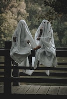 person in white hijab sitting on brown wooden bench